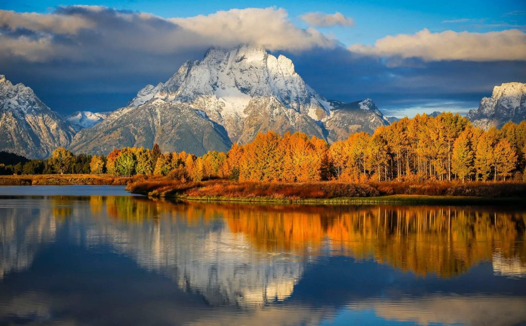 landscape with mountain, forest and lake at golden hour