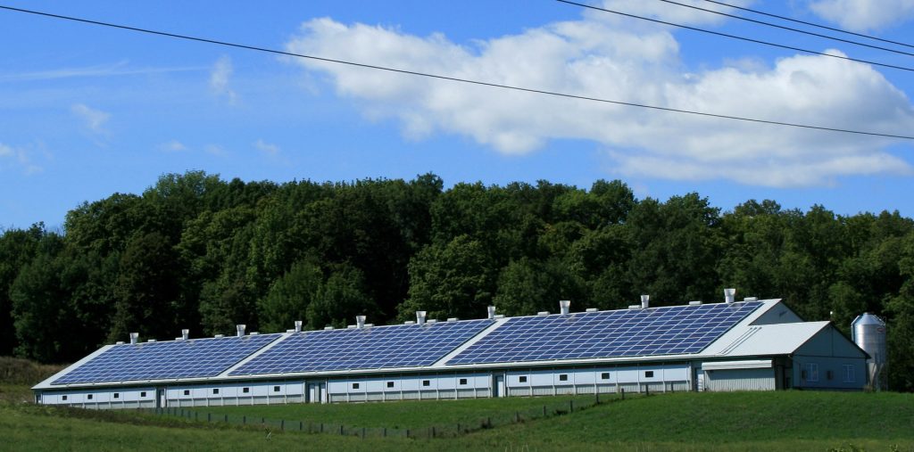 farm building with solar panels on the roof