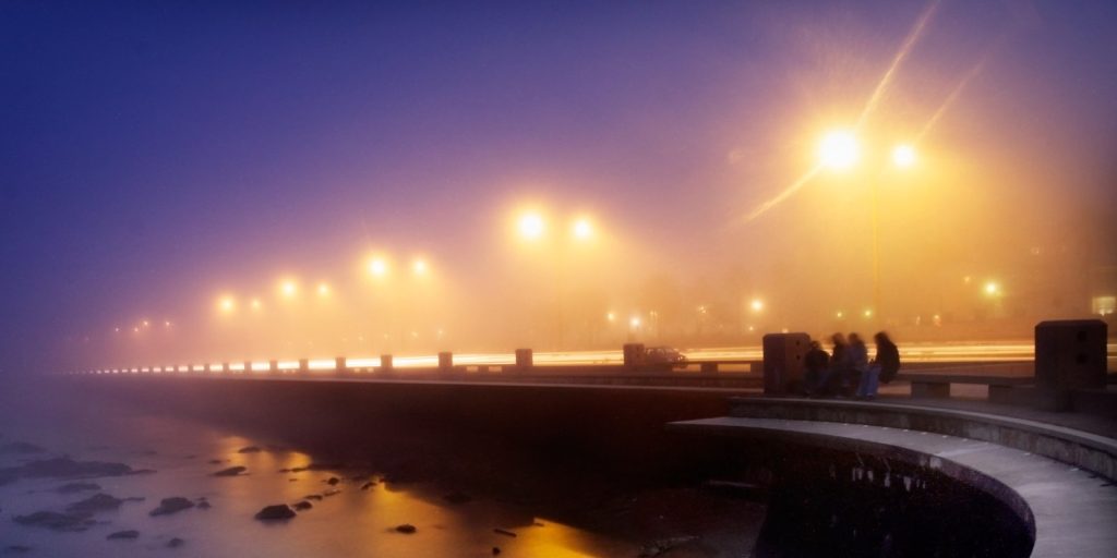 floodlights on a road near the water