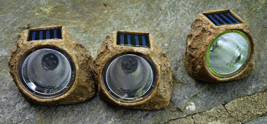 solar powered uplighting with the appearance of rocks