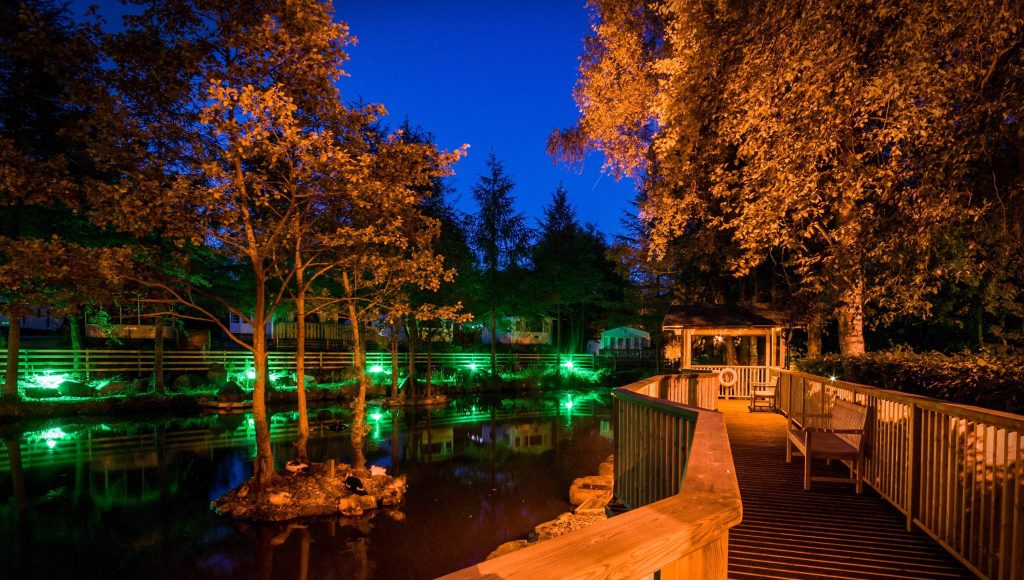 fence with lights near the water feature