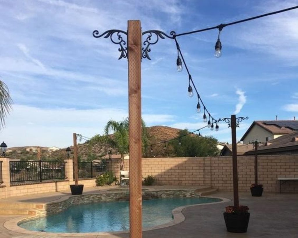 pole planters with string light hooks; how to hang outdoor string lights from planters