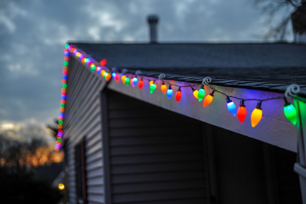 roof house adorned with christmas string lights; how to hang outdoor string lights from roofs