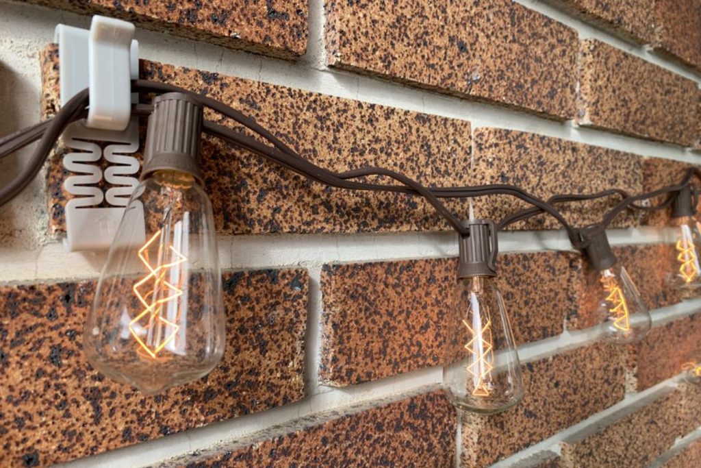 string lights on house; brick clips hook fastener; outdoor string lights on brick wall; how to hang outdoor string lights on houses